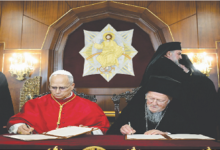 Pope Leo XIV and Ecumenical Patriarch Bartholomew I signing a joint declaration against religious violence.