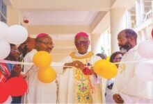 Archbihsop Kwofie cutting the ribbon. Looking on are Bishop Kumordji (left) and Rev. Fr. Akesseh (right).