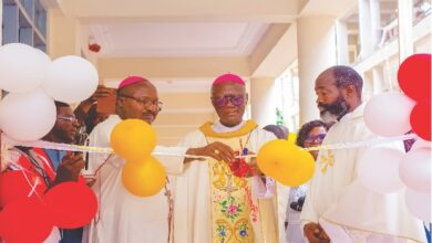Archbihsop Kwofie cutting the ribbon. Looking on are Bishop Kumordji (left) and Rev. Fr. Akesseh (right).