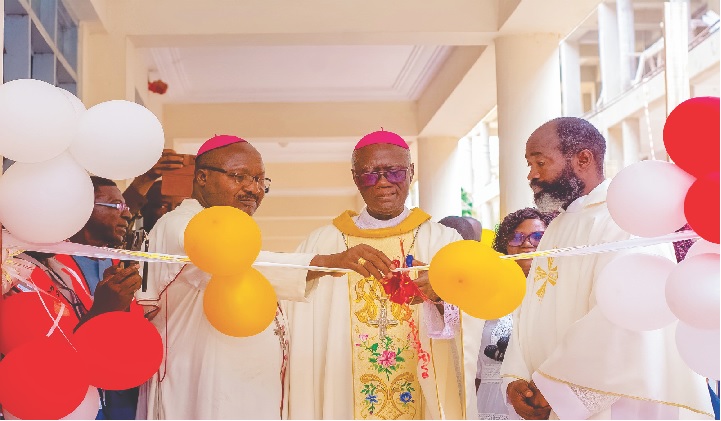 Archbihsop Kwofie cutting the ribbon. Looking on are Bishop Kumordji (left) and Rev. Fr. Akesseh (right).